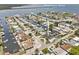 Aerial view of property showcasing waterfront location, boat dock, lush landscaping, and surrounding neighborhood at 13701 Garris Dr, Hudson, FL 34667