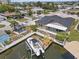 Aerial view of home featuring dock, boat lift, backyard, and waterfront access at 13701 Garris Dr, Hudson, FL 34667