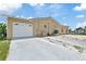 Exterior of the house with large driveway and shed at 13701 Garris Dr, Hudson, FL 34667