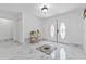 Bright foyer featuring marble flooring and decorative front doors at 13701 Garris Dr, Hudson, FL 34667