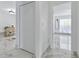 Bright hallway with marble floors, white walls, and closet at 13701 Garris Dr, Hudson, FL 34667
