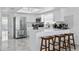 Bright kitchen with marble floors, stainless steel appliances, white cabinetry and breakfast bar with stools at 13701 Garris Dr, Hudson, FL 34667