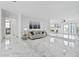 Bright and open living area with large format tiles and modern furnishings at 13701 Garris Dr, Hudson, FL 34667