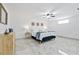 Bright main bedroom featuring marble floors, a ceiling fan, and a comfortable queen sized bed at 13701 Garris Dr, Hudson, FL 34667