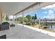 Spacious covered patio with waterfront view and comfortable outdoor seating at 13701 Garris Dr, Hudson, FL 34667