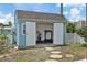 Exterior view of shed featuring double doors and stepping stone access at 13701 Garris Dr, Hudson, FL 34667