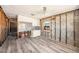 Open kitchen showcasing new floors and white cabinets under a ceiling fan at 14040 Miramar Ave, Madeira Beach, FL 33708