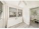 Sunroom with plenty of windows and natural light, ceiling fan, and light wood-look floors at 14040 Miramar Ave, Madeira Beach, FL 33708