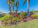 Landscaped backyard features beautiful colorful plants, palm trees and tasteful outdoor decorations at 14173 90Th Ave, Seminole, FL 33776