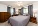 Comfortable bedroom featuring soft grey linens, wood furnishings, and bright natural light at 14173 90Th Ave, Seminole, FL 33776