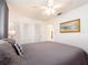 Spacious bedroom features plush grey bedding, white walls, and ample closet space at 14173 90Th Ave, Seminole, FL 33776