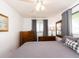 Well-lit bedroom with grey linens, wood furnishings, and wall art at 14173 90Th Ave, Seminole, FL 33776