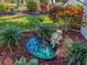 Beautiful water fountain surrounded by lush greenery and wood chips, adding a peaceful touch to the garden at 14173 90Th Ave, Seminole, FL 33776