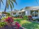 Charming home featuring a well-manicured front yard with lush landscaping and vibrant flower beds at 14173 90Th Ave, Seminole, FL 33776