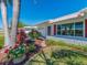 Beautifully landscaped front yard featuring colorful flowerbeds, stone pathways, and mature trees at 14173 90Th Ave, Seminole, FL 33776