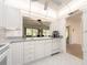 Bright kitchen with white cabinets, gray counters, undermount sink and view to the lanai at 14173 90Th Ave, Seminole, FL 33776