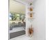 The lanai entrance has decorative shelves displaying charming figurines and a view of the outdoors at 14173 90Th Ave, Seminole, FL 33776