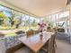 Enclosed lanai features a dining table perfect for enjoying meals with a beautiful green outdoor view at 14173 90Th Ave, Seminole, FL 33776