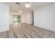 Spacious living room featuring neutral walls, a ceiling fan, and stylish wood-look flooring at 14173 90Th Ave, Seminole, FL 33776