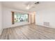 Bright living room with neutral walls, ceiling fan, and attractive wood-look flooring at 14173 90Th Ave, Seminole, FL 33776