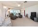 Bright living room featuring comfortable seating, a ceiling fan, and ample natural light at 14173 90Th Ave, Seminole, FL 33776