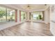 Bright sun room with large windows and wood-look flooring, offering serene backyard views at 14173 90Th Ave, Seminole, FL 33776