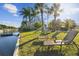 Inviting backyard with tropical landscaping, waterfront access and relaxing lounge chairs at 14924 Old Dixie Hwy, Hudson, FL 34667