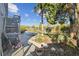Landscaped backyard with tropical foliage, a patio area, and serene waterfront views at 14924 Old Dixie Hwy, Hudson, FL 34667