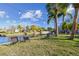 Waterfront backyard featuring lawn chairs with a canal view and bright sky at 14924 Old Dixie Hwy, Hudson, FL 34667