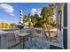 Relaxing balcony with a table, umbrella, chairs and a view of the water at 14924 Old Dixie Hwy, Hudson, FL 34667