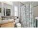 Bathroom featuring a single sink vanity, matching faucet, and fun turtle shower curtain at 14924 Old Dixie Hwy, Hudson, FL 34667