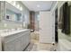 Bright bathroom features a double sink vanity and tiled shower with a view of a soaking tub at 14924 Old Dixie Hwy, Hudson, FL 34667