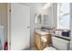 Bright bathroom featuring a single sink vanity, updated lighting, and toilet with storage shelf at 14924 Old Dixie Hwy, Hudson, FL 34667