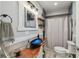 Stylish bathroom featuring a unique blue glass vessel sink on a wooden countertop and a shower with a curtain at 14924 Old Dixie Hwy, Hudson, FL 34667