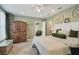 Cozy bedroom with soft green walls, neutral bedding, and a rustic wood accent wall at 14924 Old Dixie Hwy, Hudson, FL 34667