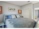 Bedroom featuring a comfortable bed with blue accents, side table, and closet at 14924 Old Dixie Hwy, Hudson, FL 34667