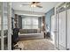 Brightly lit room with a pull out sofa, a ceiling fan, and a big window allowing for natural light at 14924 Old Dixie Hwy, Hudson, FL 34667