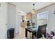 Open dining area adjacent to the kitchen, featuring a glass table and modern light fixture at 14924 Old Dixie Hwy, Hudson, FL 34667