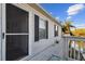 Exterior view of a home with a deck overlooking the water and a screened door at 14924 Old Dixie Hwy, Hudson, FL 34667