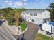 Exterior view of a well-maintained home with a circular driveway and mature landscaping at 14924 Old Dixie Hwy, Hudson, FL 34667