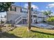 Exterior of home featuring a spacious backyard, deck, and outdoor seating areas for relaxation at 14924 Old Dixie Hwy, Hudson, FL 34667