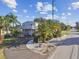Charming home with circular driveway, lush landscaping, and inviting curb appeal on a sunny day at 14924 Old Dixie Hwy, Hudson, FL 34667