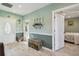 Welcoming foyer featuring decorative details, wood-look tile, and convenient access to the bedroom at 14924 Old Dixie Hwy, Hudson, FL 34667