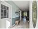 Inviting foyer with wood-look tile flooring, a charming bench, and natural light at 14924 Old Dixie Hwy, Hudson, FL 34667