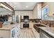 The bright kitchen showcases granite countertops, stainless steel appliances, and a beautiful copper farmhouse sink at 14924 Old Dixie Hwy, Hudson, FL 34667