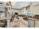 Bright kitchen with a copper farmhouse sink, stainless appliances, granite countertops, and a brick backsplash at 14924 Old Dixie Hwy, Hudson, FL 34667