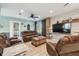 Spacious living room with natural light, cozy seating, and access to the outdoors at 14924 Old Dixie Hwy, Hudson, FL 34667