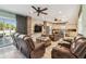 Cozy living room featuring comfortable seating, brick accents, and an open view to the kitchen at 14924 Old Dixie Hwy, Hudson, FL 34667