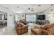 Bright living room with wood-look floors, leather seating, and view to the outdoor deck at 14924 Old Dixie Hwy, Hudson, FL 34667