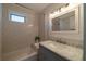 Bright bathroom featuring a tub with white subway tile, complemented by a marble countertop at 1510 49Th N St, St Petersburg, FL 33710